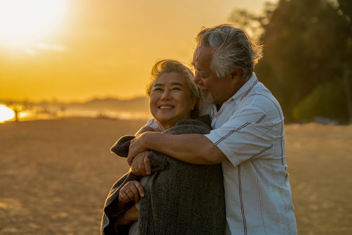 Elder law and Medi-Cal planning concept: Asian elderly family on beach vacation. 